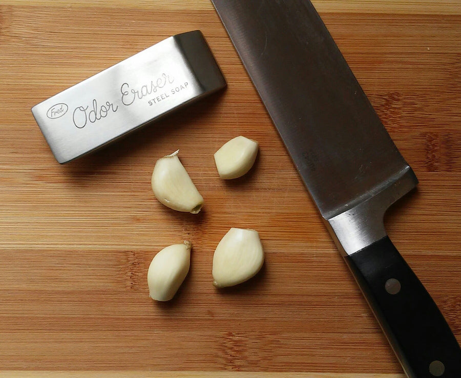 Odor Eraser On Cutting Board With Garlic And Knife